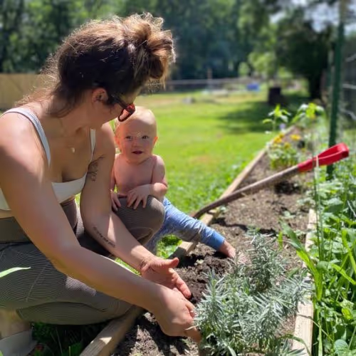 Tiny Health mom with baby planting garden