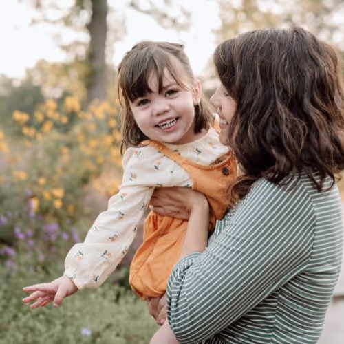 mom holding daughter
