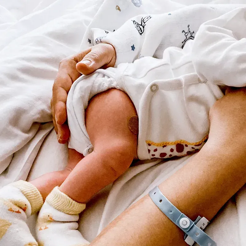 A close-up of a mother holding her newborn baby in the hospital