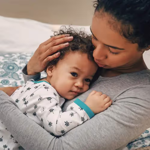 Mother comforts her child who is dealing with an ear infection