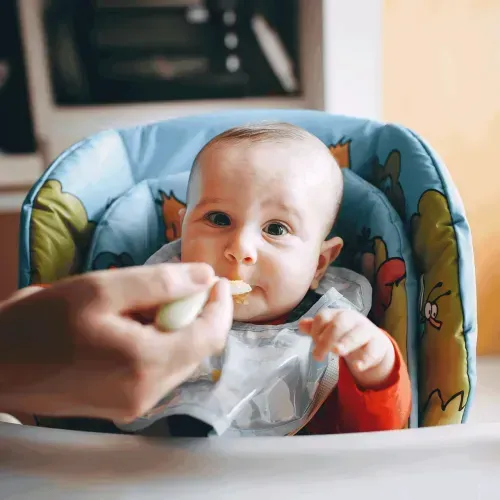 Baby eating from a spoon, representing parents' concerns over arsenic in baby food