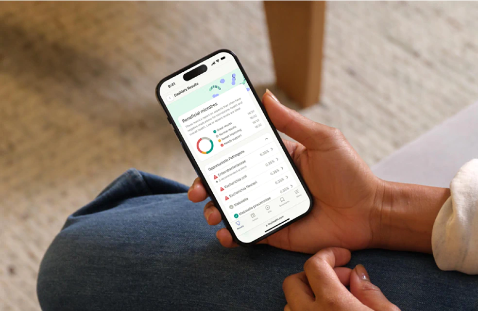 User checking their microbiome test results on the Tiny Health mobile app.