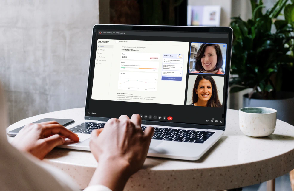 Virtual consultation with Tiny Health specialists reviewing microbiome test results on laptop