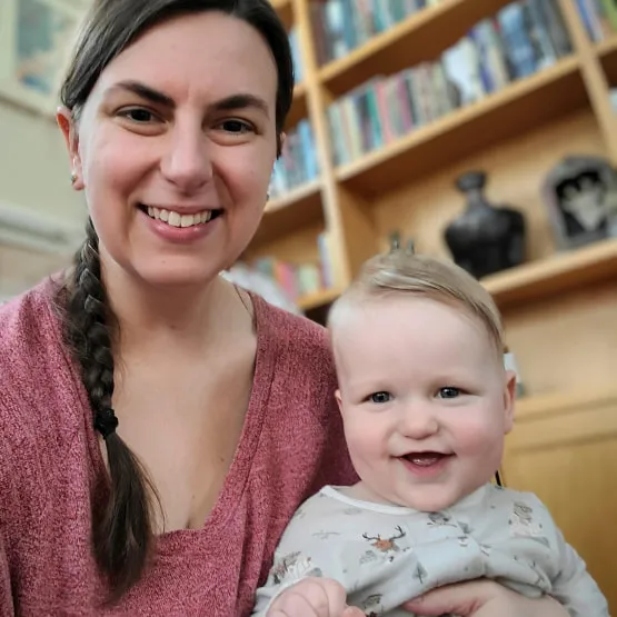 A picture of a happy mom with her baby smiling