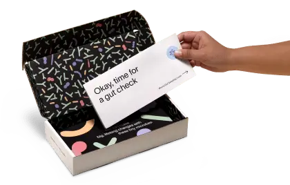 A hand is placing an envelope into an open Tiny Health.
