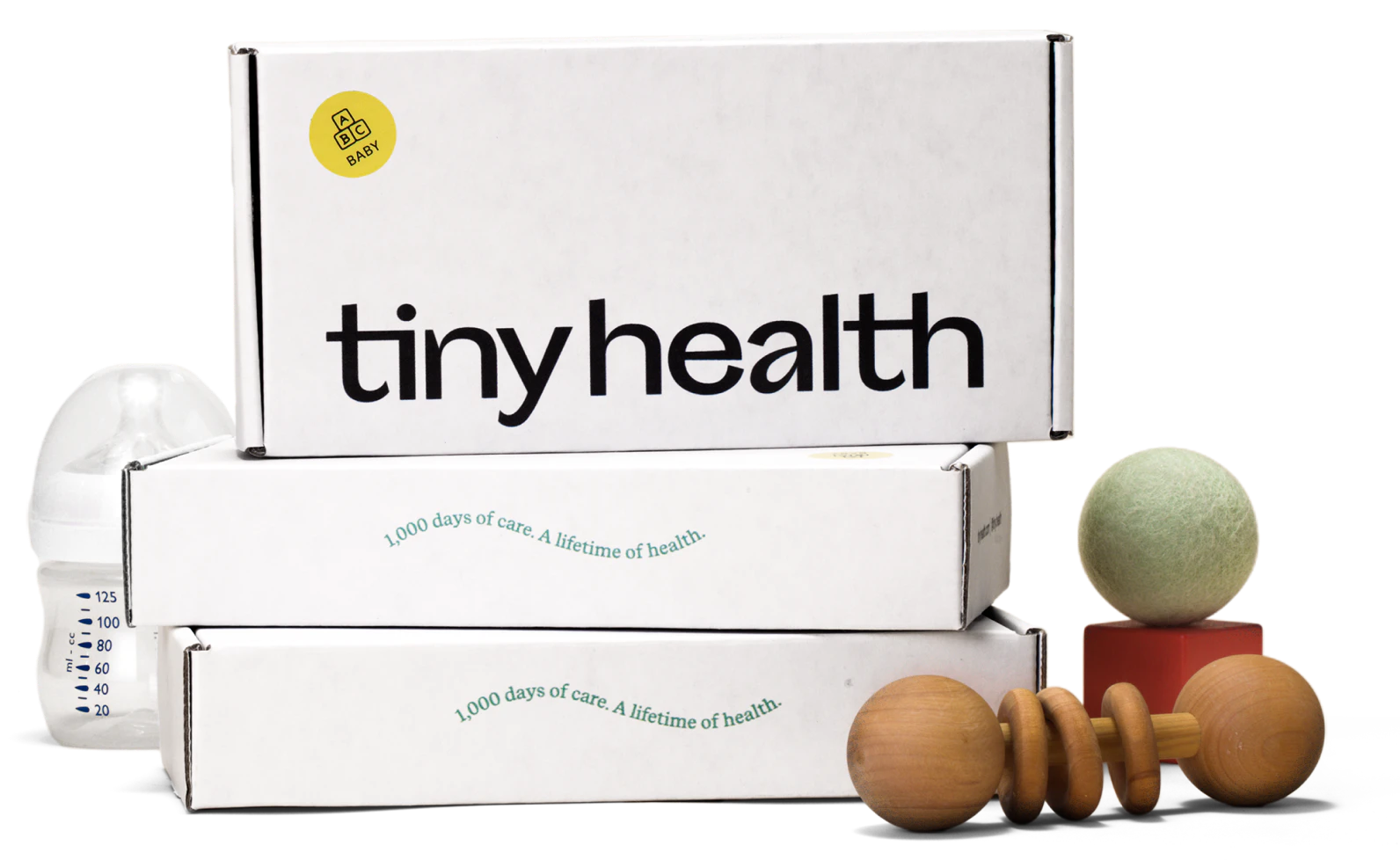 3 boxes of gut health tests stacked on top of one another with baby toys around it