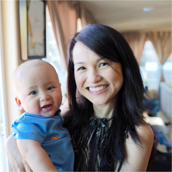 A picture of a happy mom with her baby smiling.