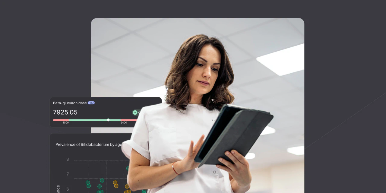 A healthcare professional in a lab coat is holding a tablet, focused on the screen, with graphs and data displayed in the background.