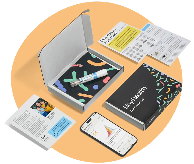 Tiny Health gut test kit showing collection tube, instructions, packaging, welcome letter, and smartphone displaying results