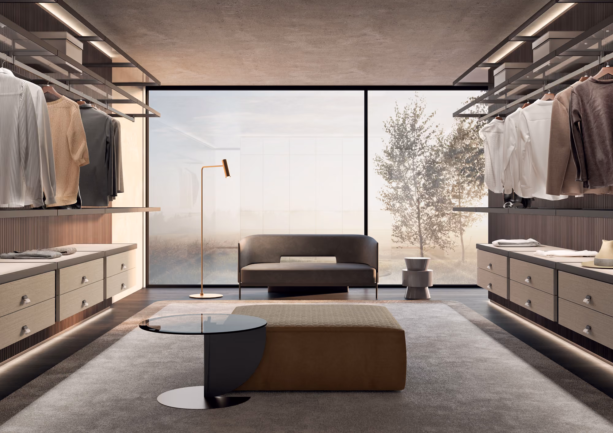 Modern walk-in closet with hanging clothes, a gray sofa, floor lamp, and a low table on a rug.