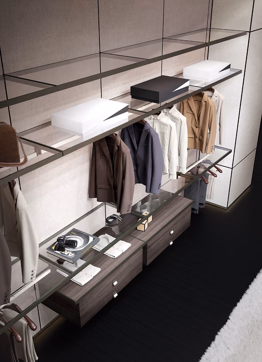 Modern closet with glass shelves holding folded clothes, suit jackets, boxes, and accessories.