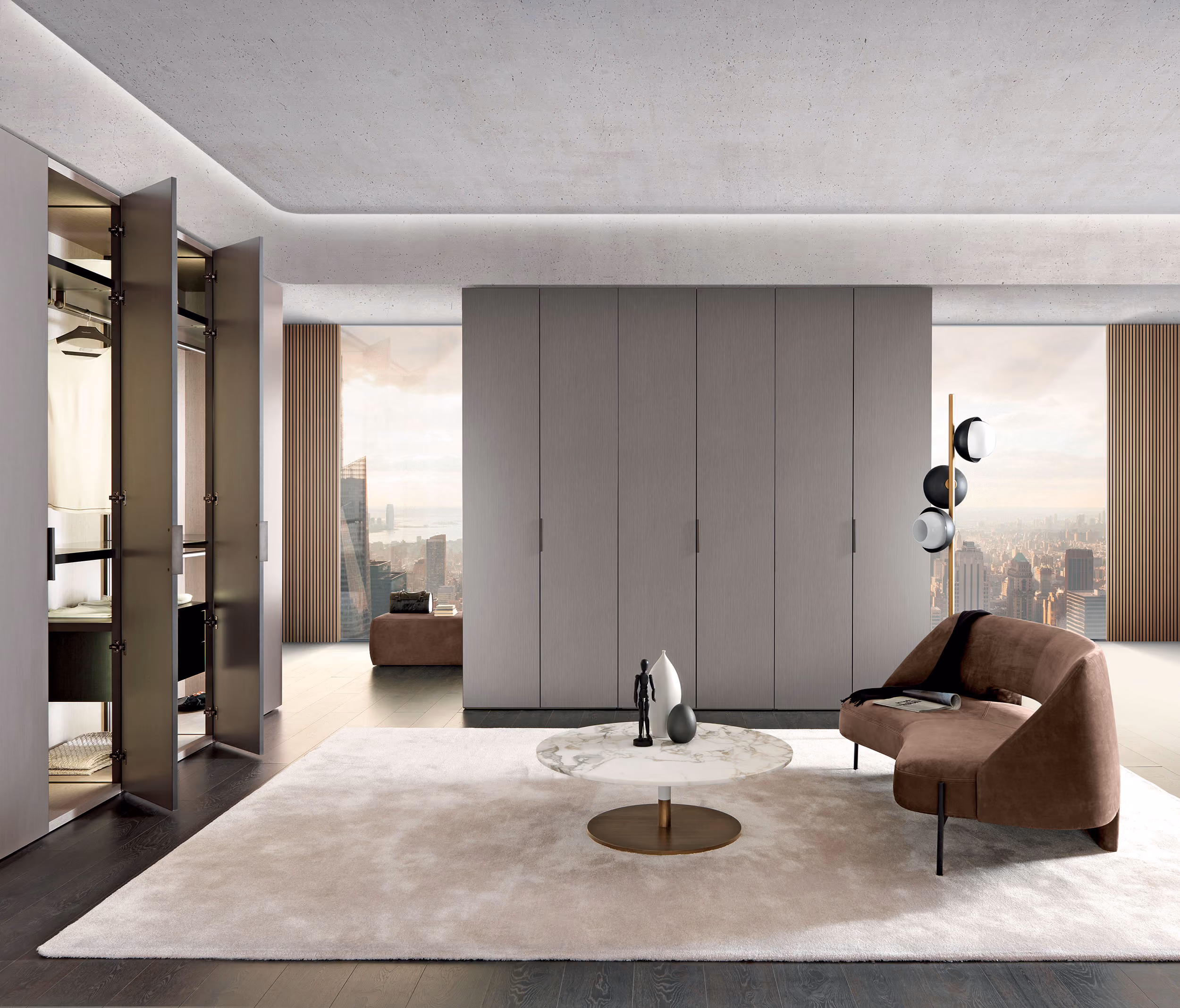 Modern living area with brown curved sofa, round marble table, large rug, and city skyline view.