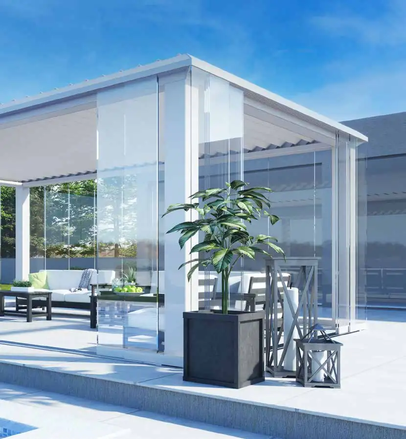 Modern outdoor lounge area with white pergola featuring transparent glass walls, a large potted plant, wooden lanterns, and white cushioned seating by a pool under a clear blue sky.