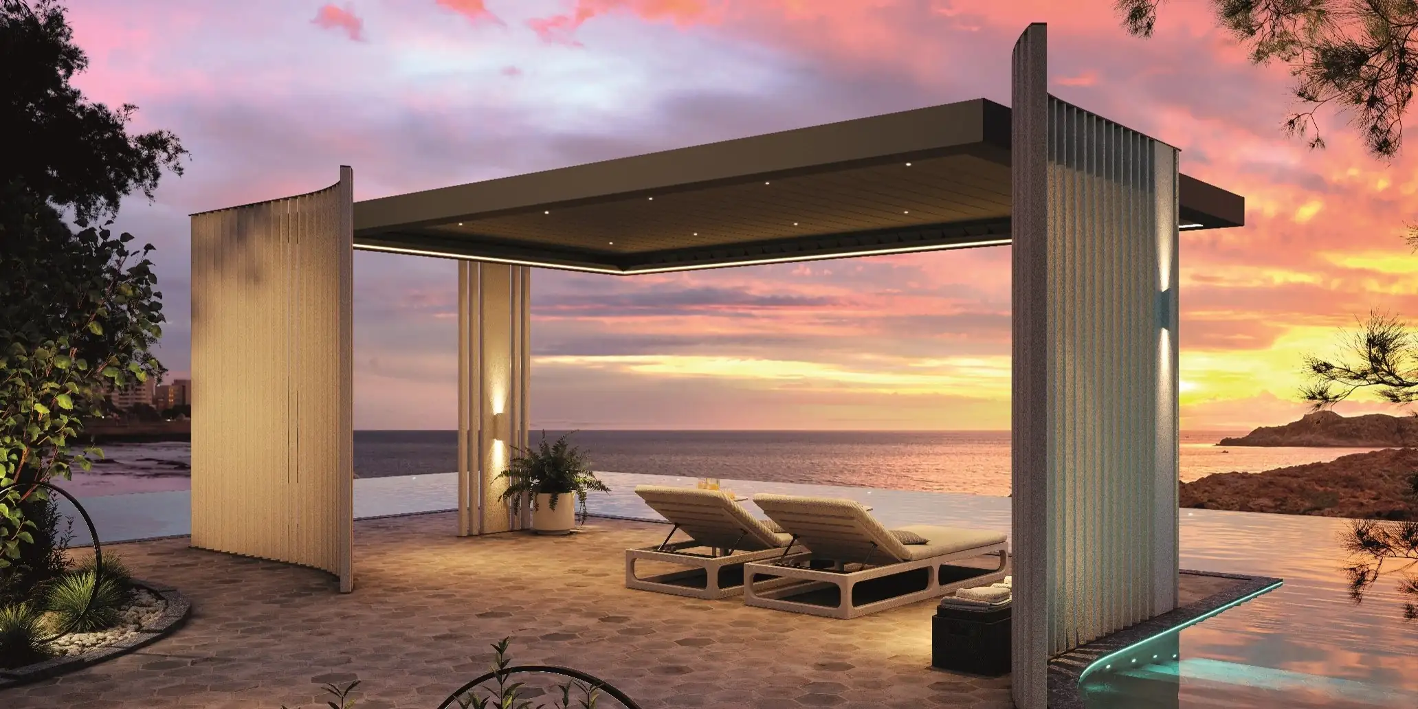 Modern outdoor pergola with ceiling lights and two cushioned lounge chairs on a tiled patio overlooking an infinity pool and the ocean at sunset.