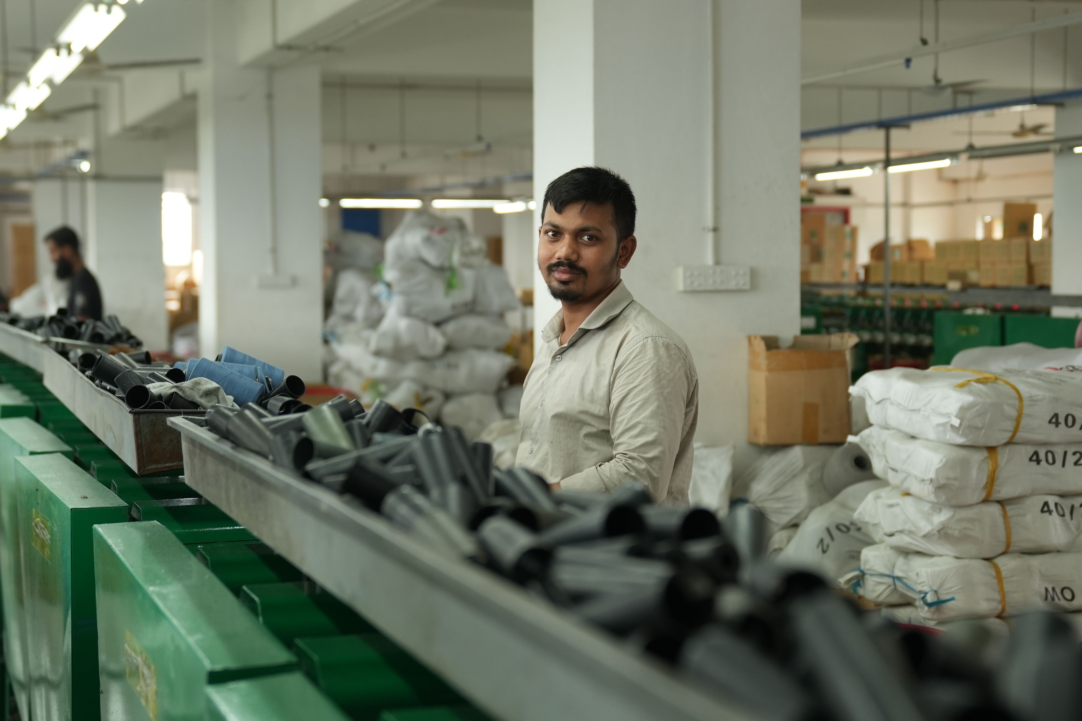 Manufacturing team member operating production machinery