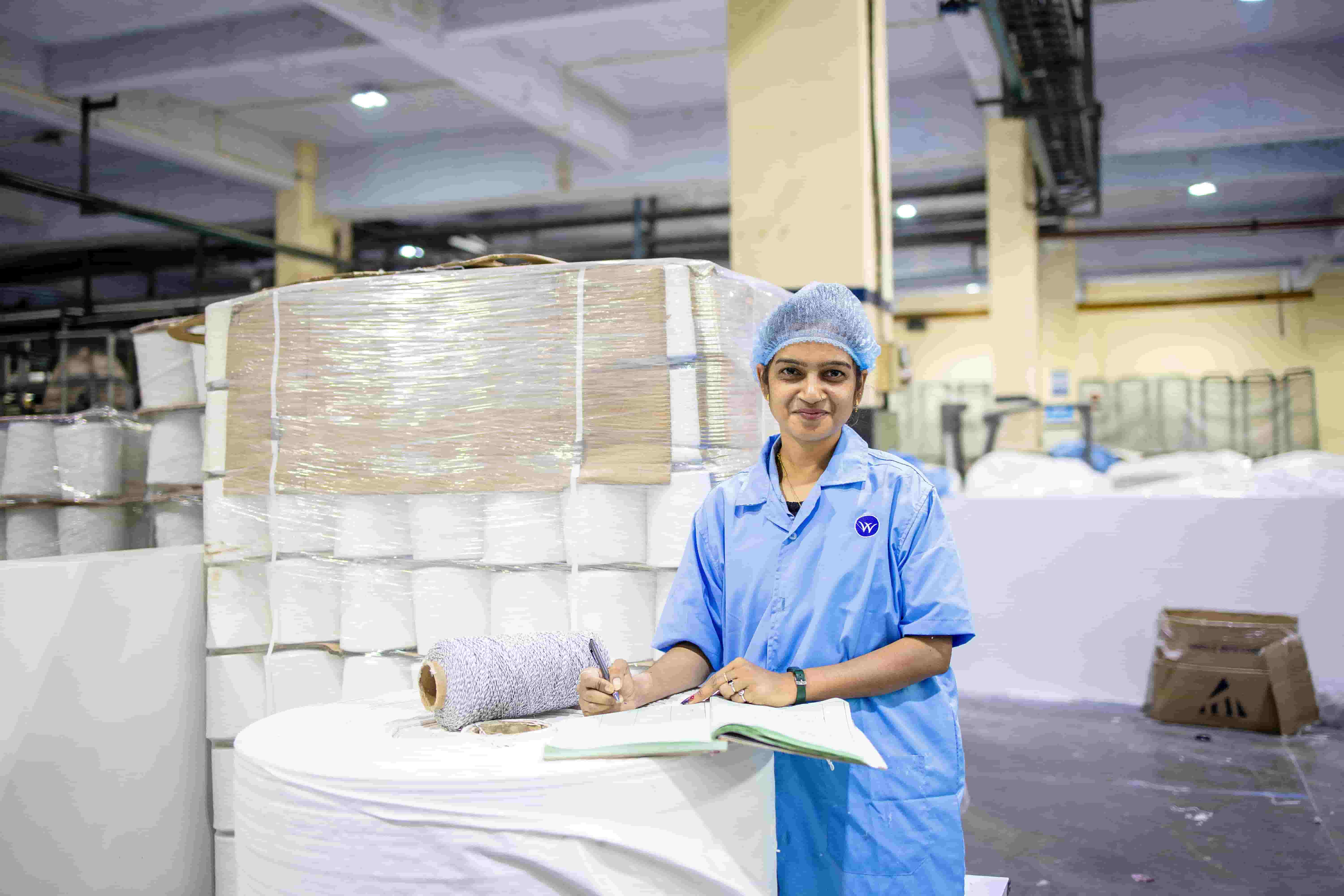 a production floor manager inspecting work at workstations.