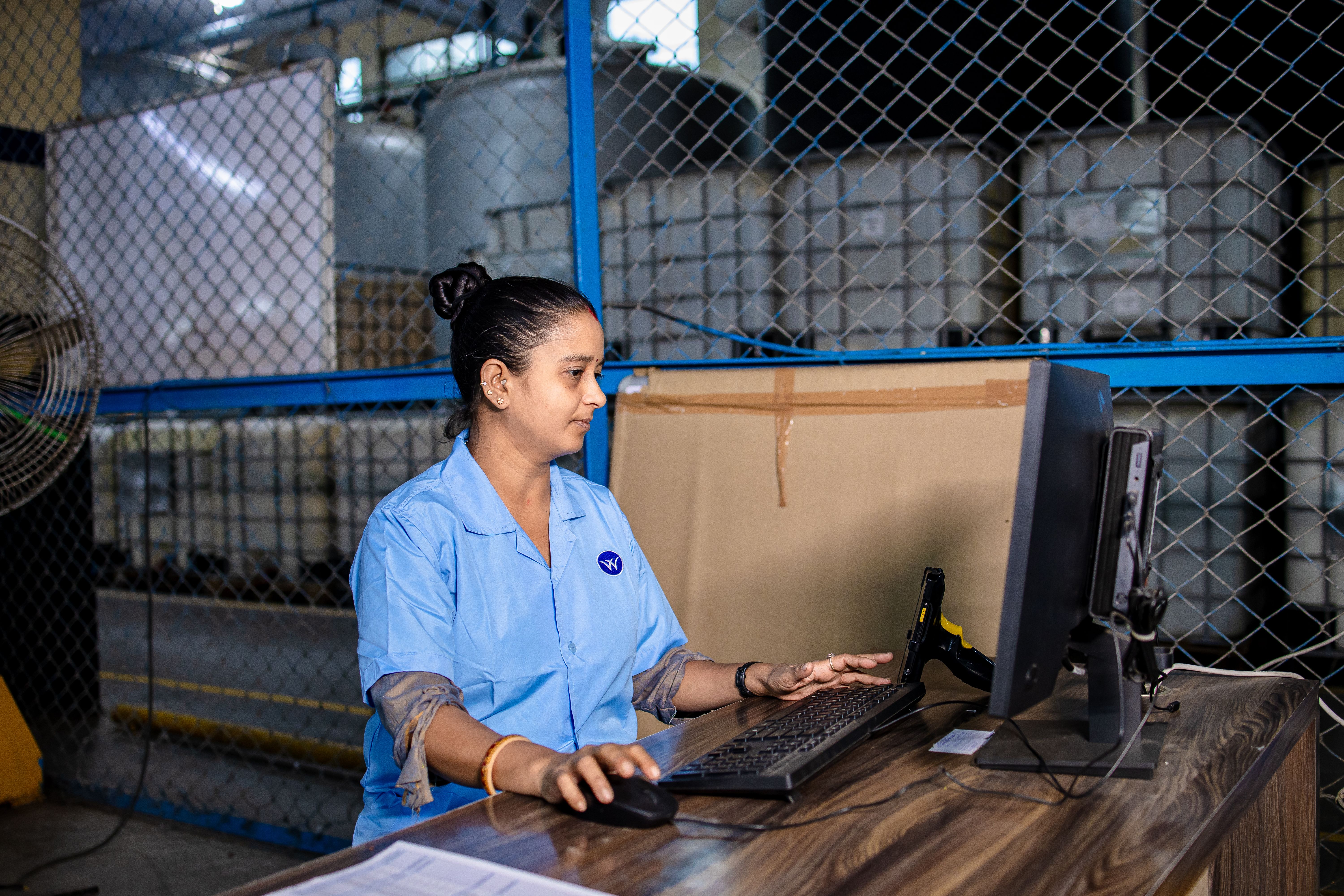 Manufacturing team member operating production machinery