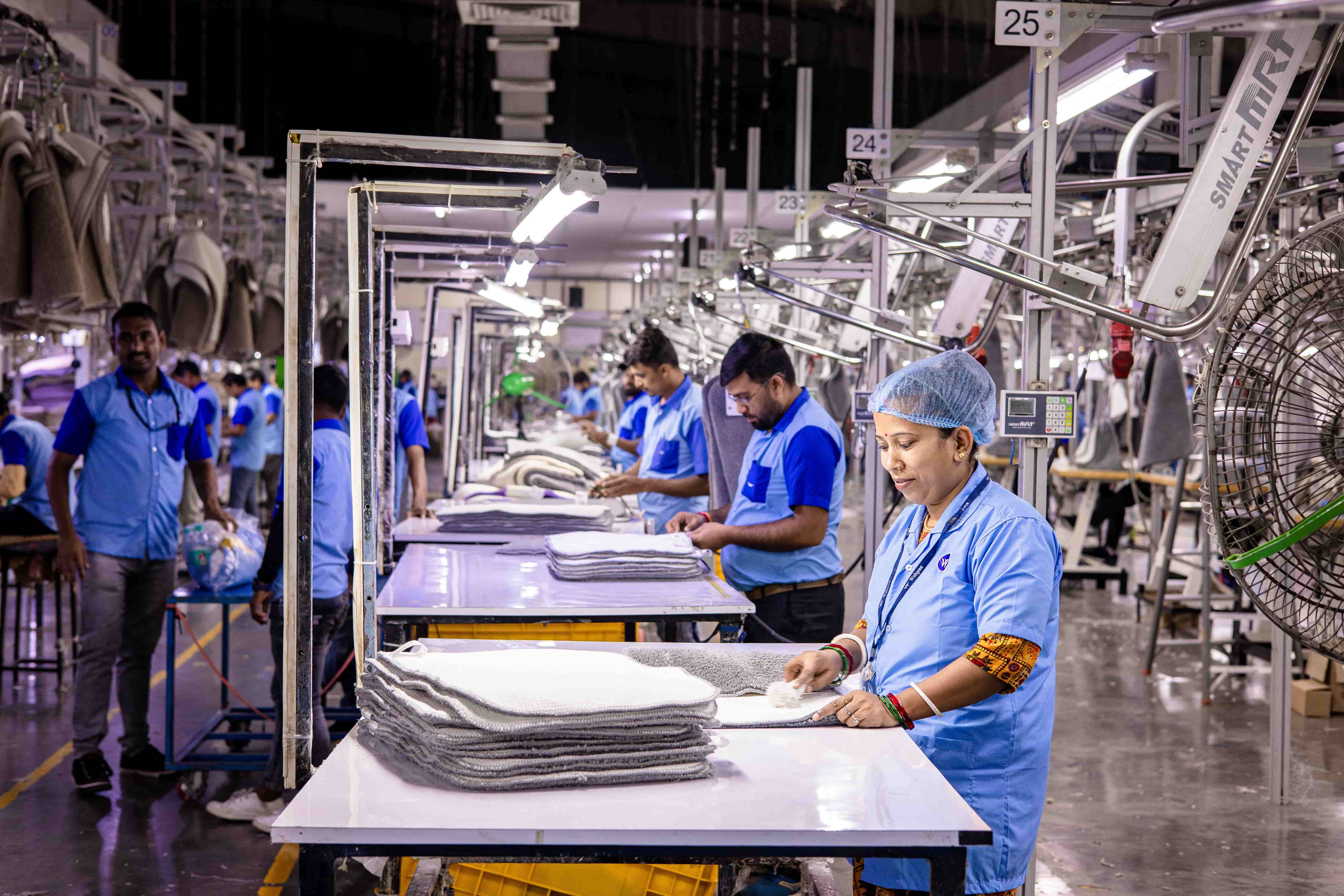 operators standing over a production line, pointing toward the time.