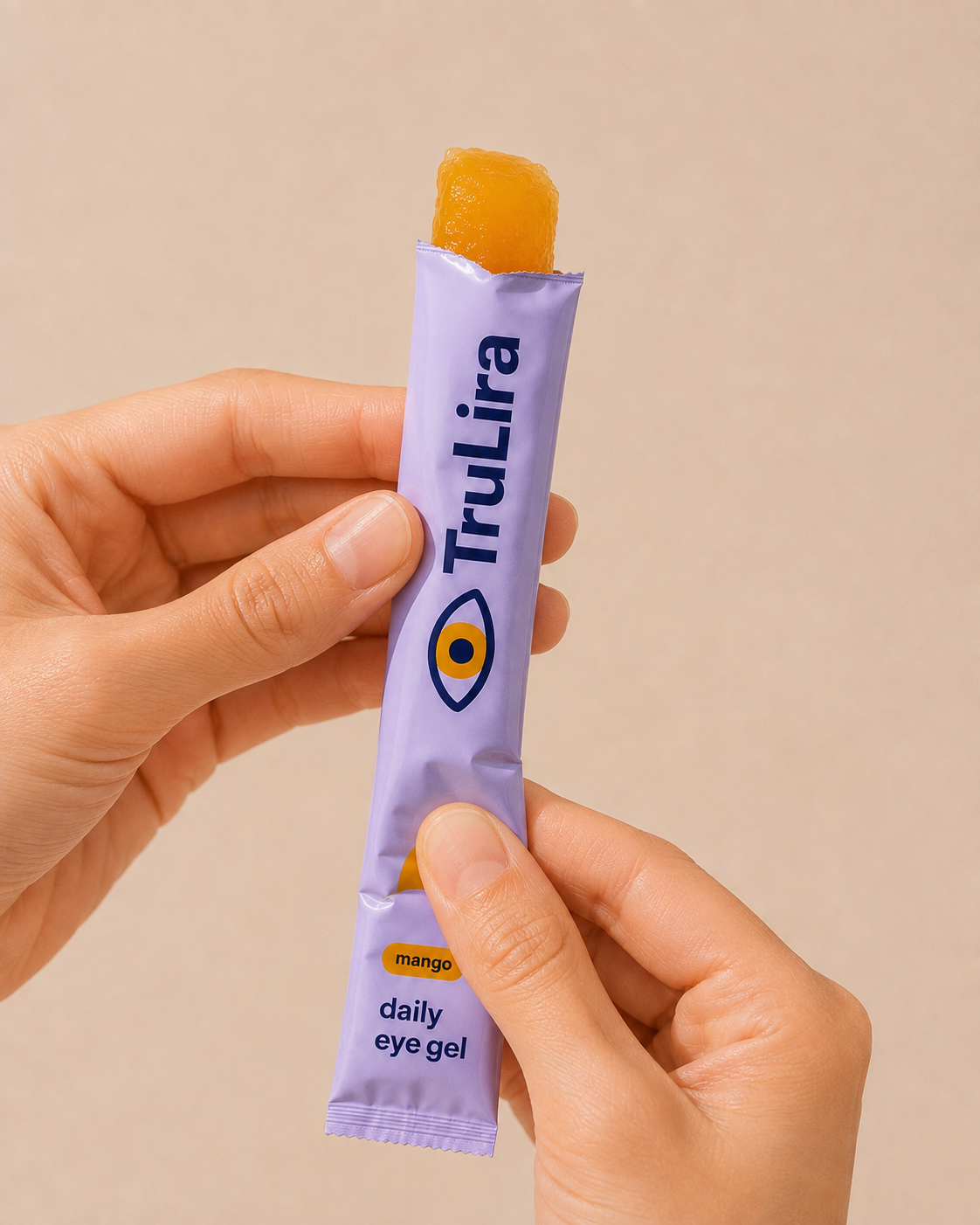 Hands squeezing soft mango gel upward from an open TruLira stick pack.