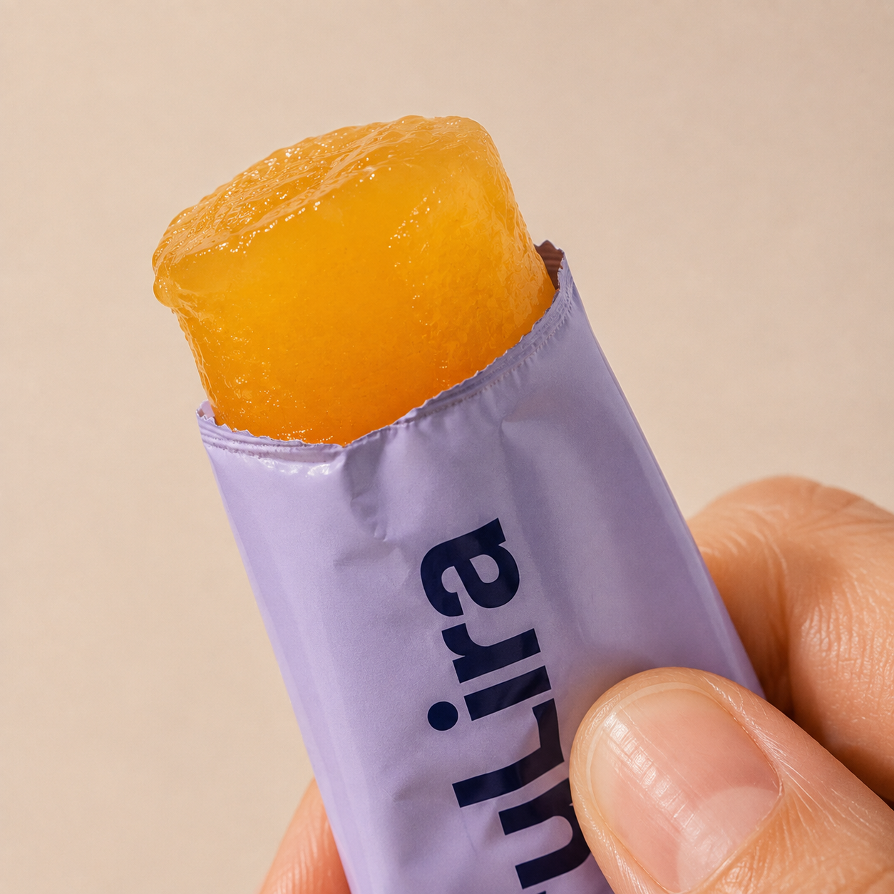 Soft mango gel emerging from a torn TruLira stick pack.