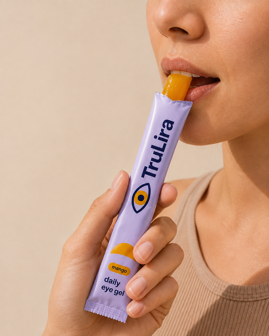 Person biting mango gel directly from their own open TruLira stick pack.