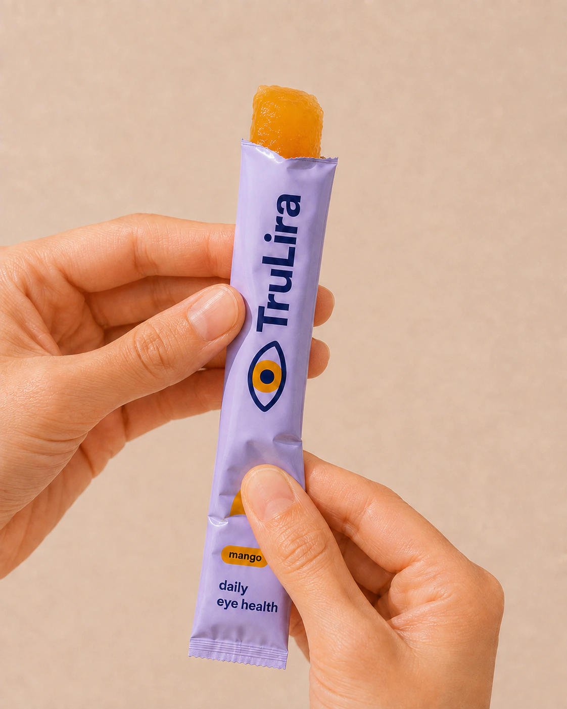 Soft mango gel squeezed upward from the open sachet.