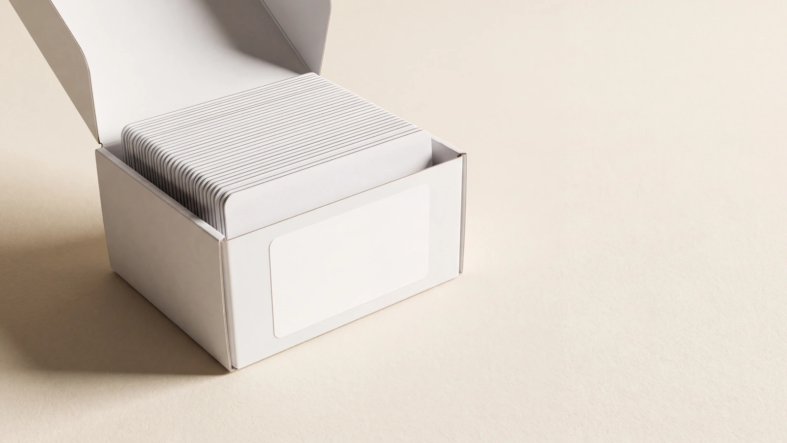 Open white box of blank plastic cards packed for white label supply