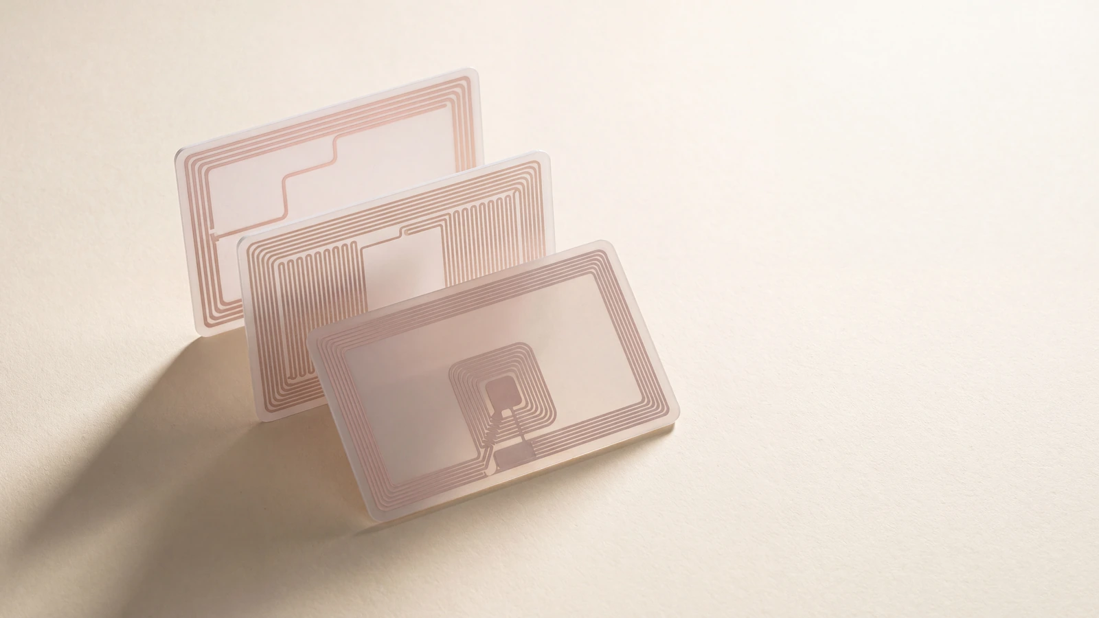 Three RFID cards showing their internal chip and antenna layouts side by side