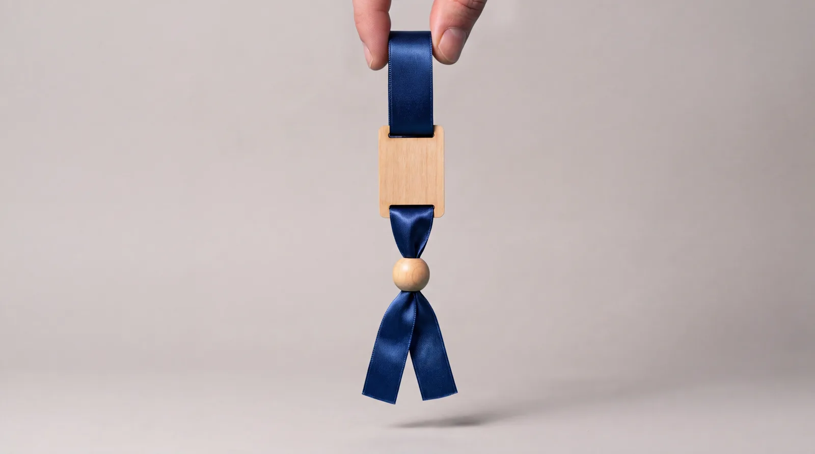 RFID fabric wristband in navy satin with a natural wood tag and a wooden bead closure