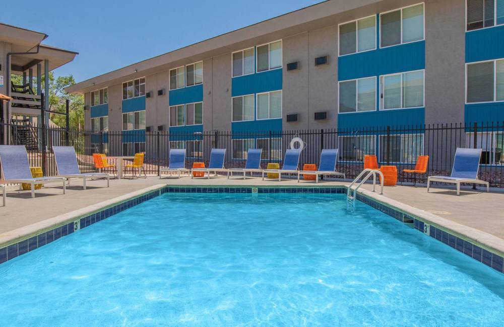 Pool with lounge chairs around it