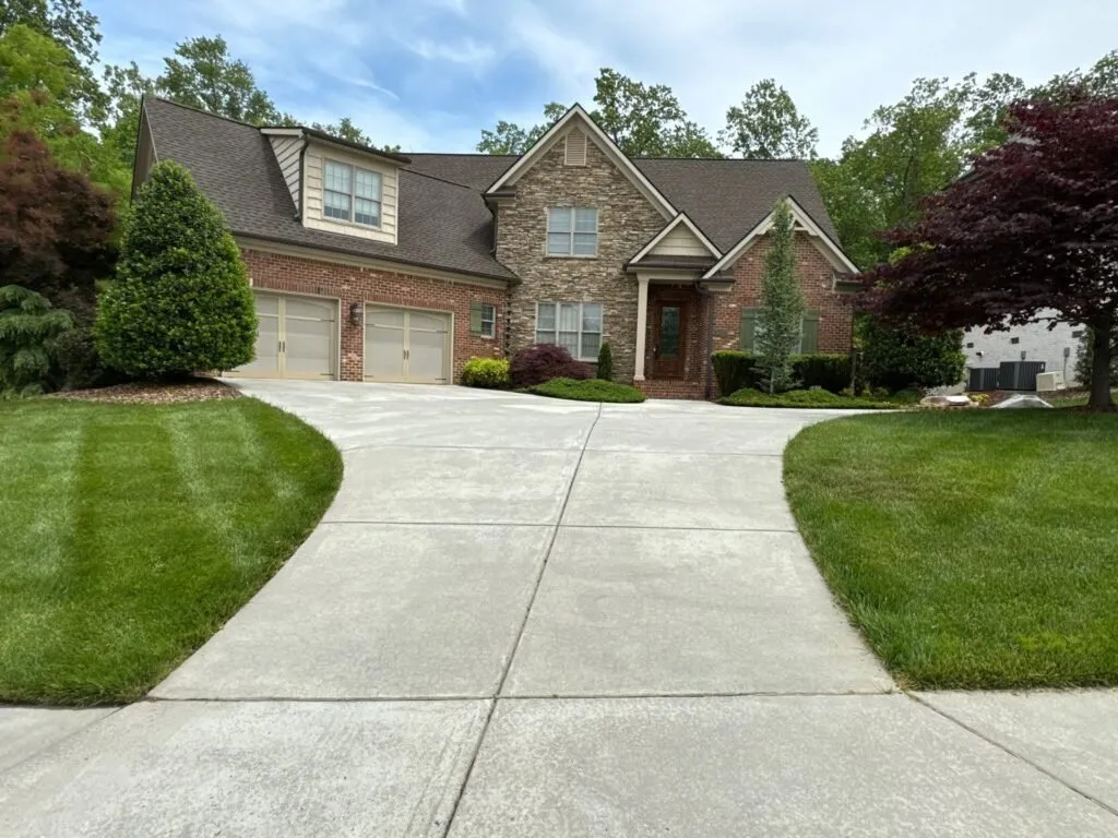 Freshly pressure washed brick home and driveway in Winston-Salem, NC