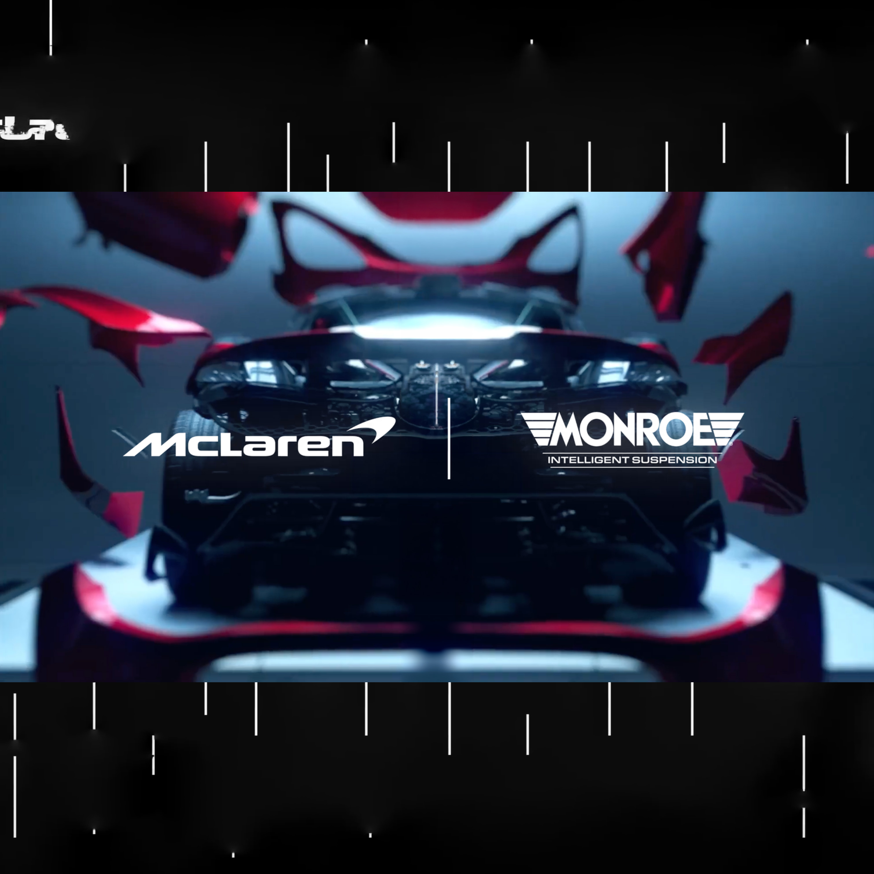 Dark sports car with its red body panels appearing to float away, displaying McLaren and Monroe Intelligent Suspension logos side by side.