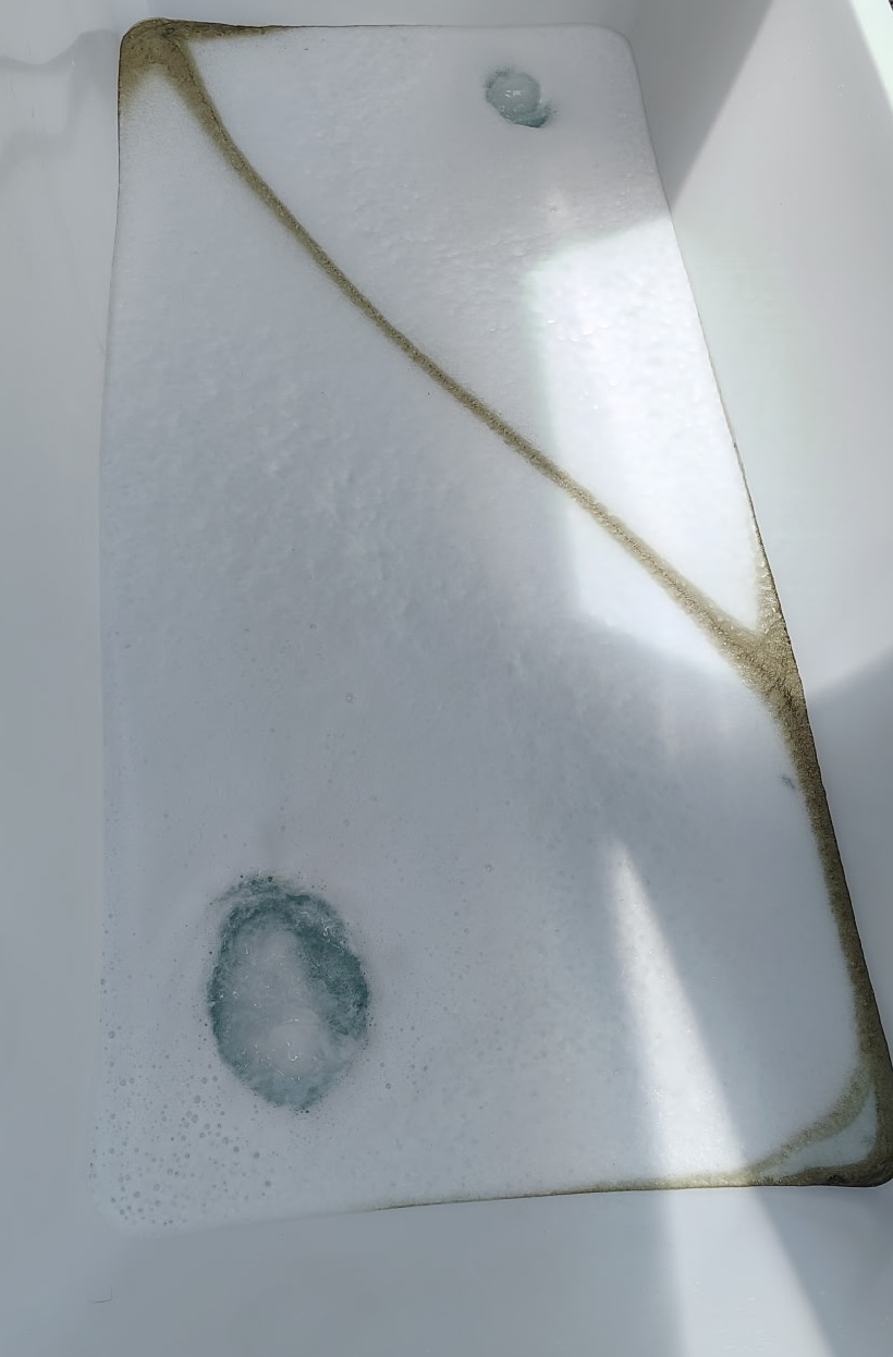 Cold plunge tub showing residue buildup along the waterline before THE DEEP cleaning.