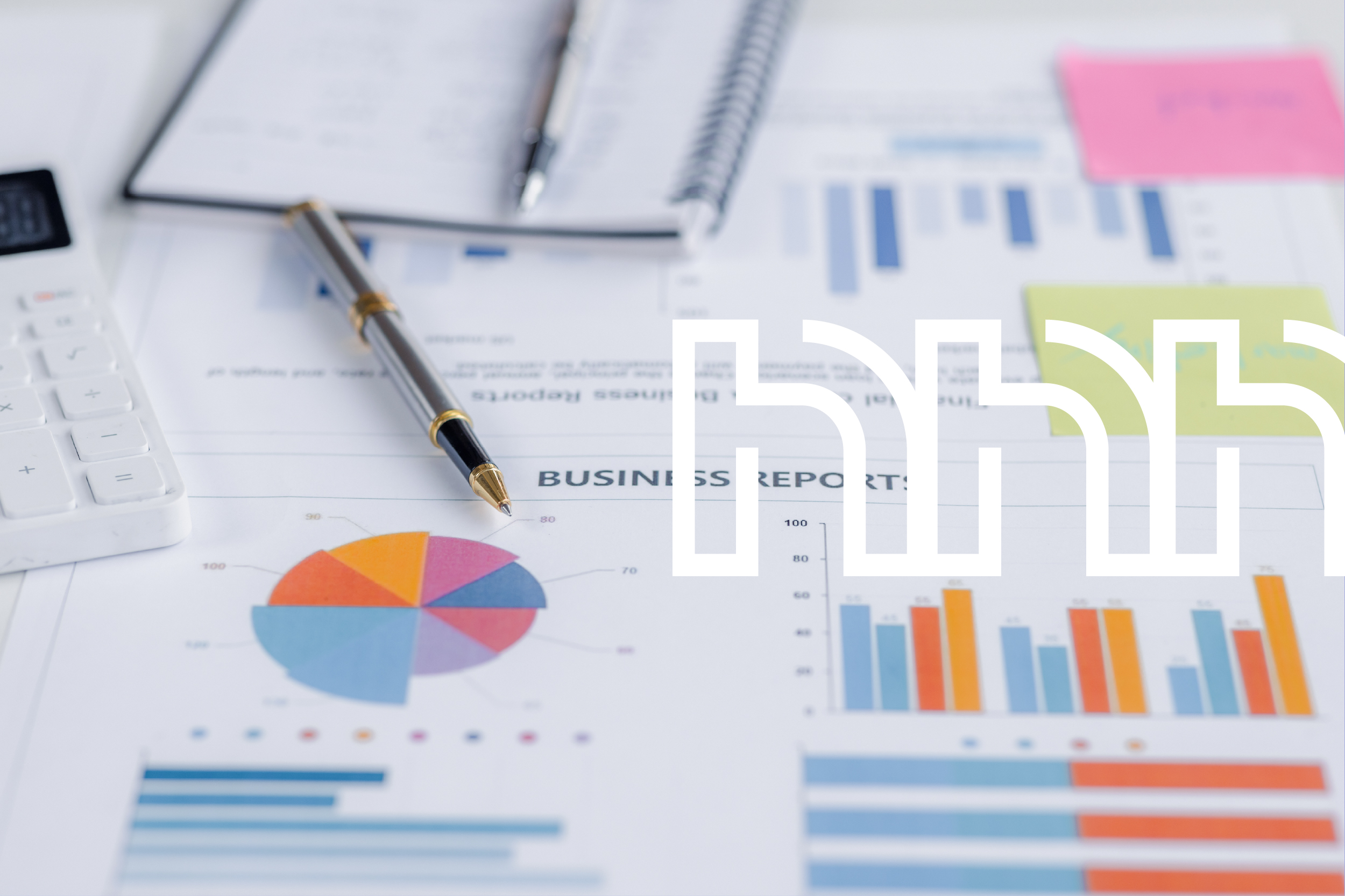 Printed business reports and notes on a desk.
