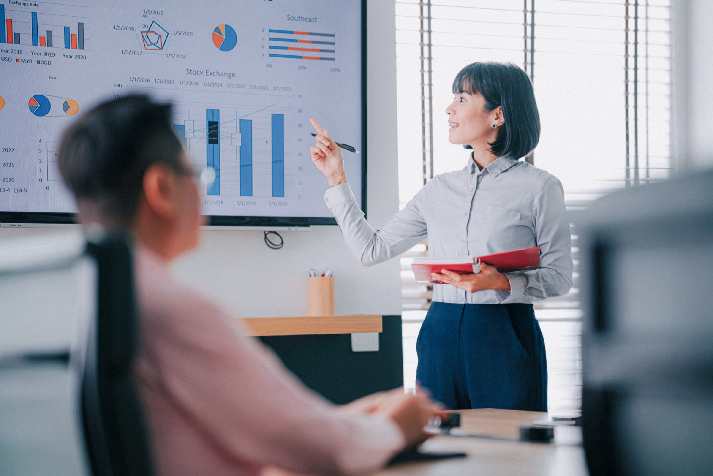 An operator presenting a written report in a meeting.