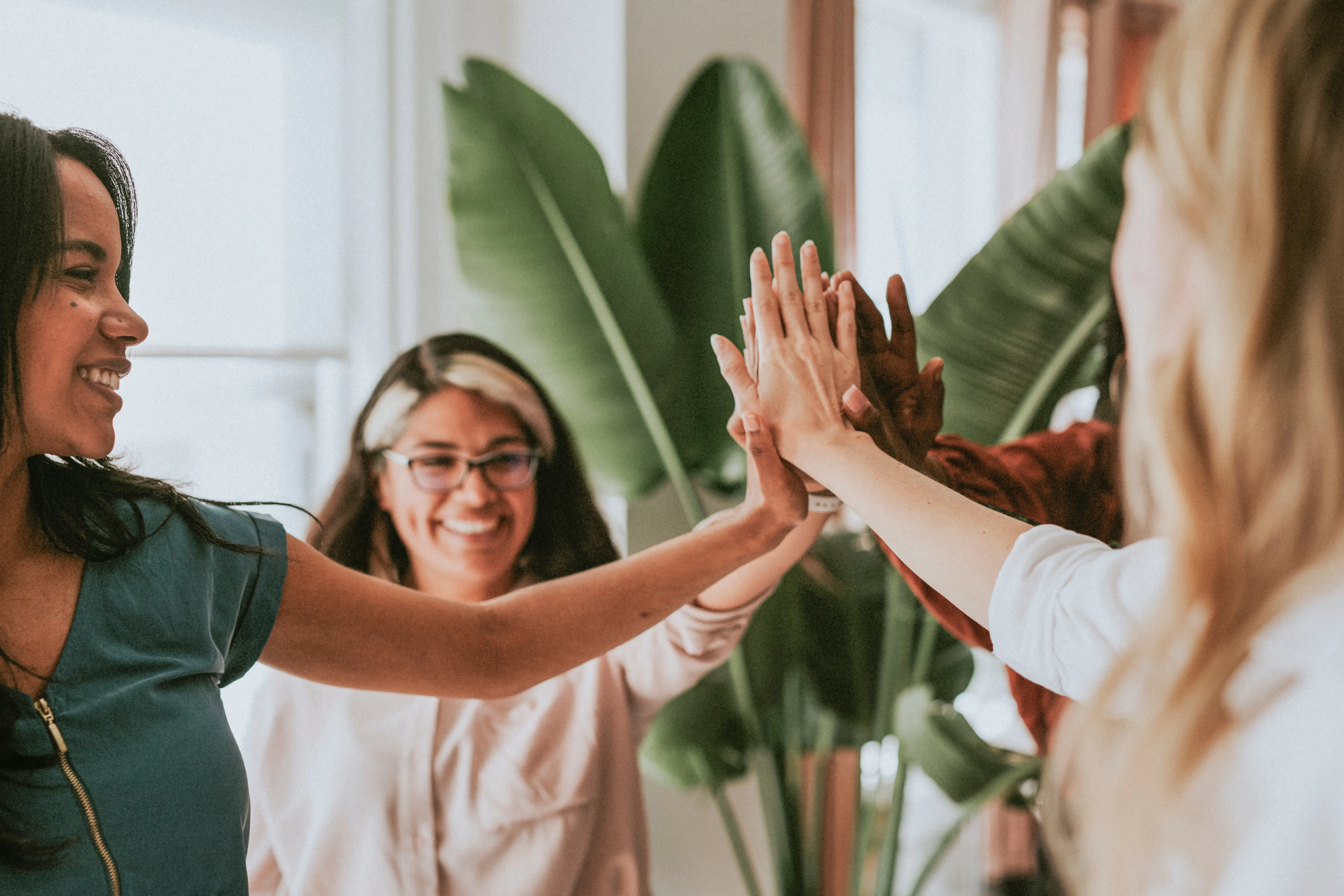 Group of women celebrating with a high five