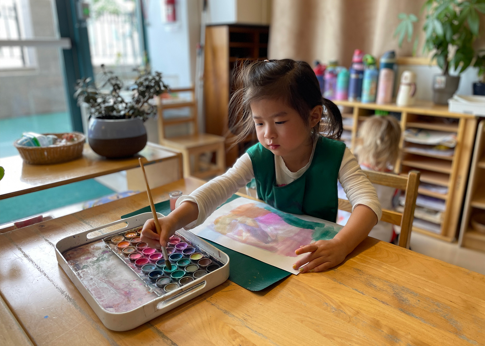 A student working with watercolors during class.