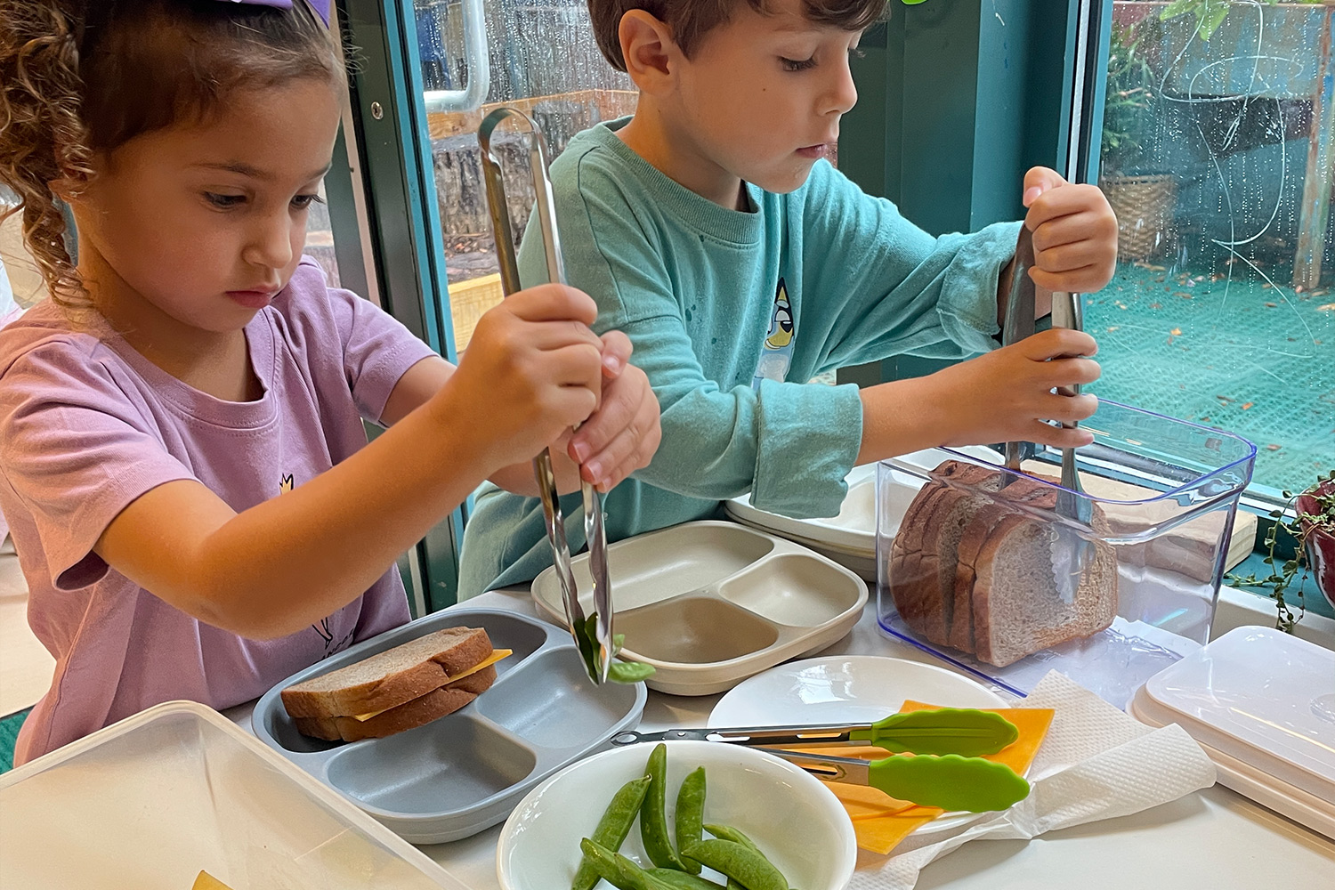 students prepping sandwiches and edamame for snack