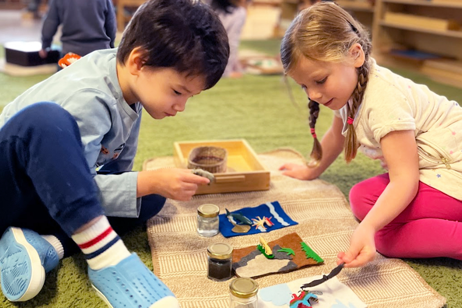 Two students working together on a project at Battery Park Montessori