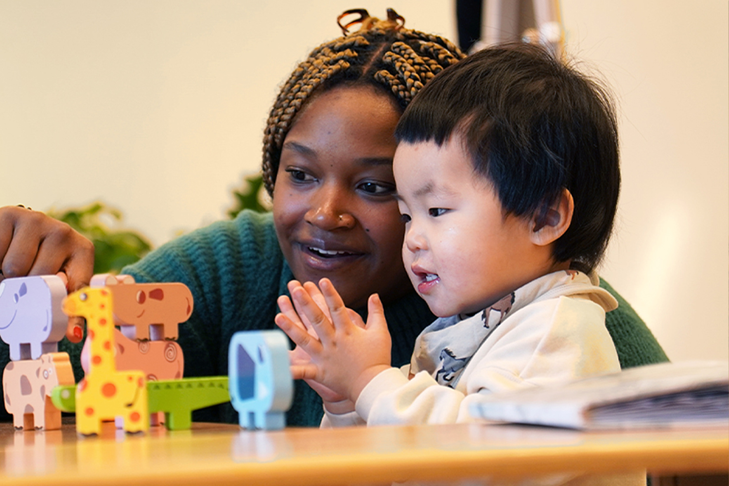 Battery Park Montessori teacher working with student on block stacking