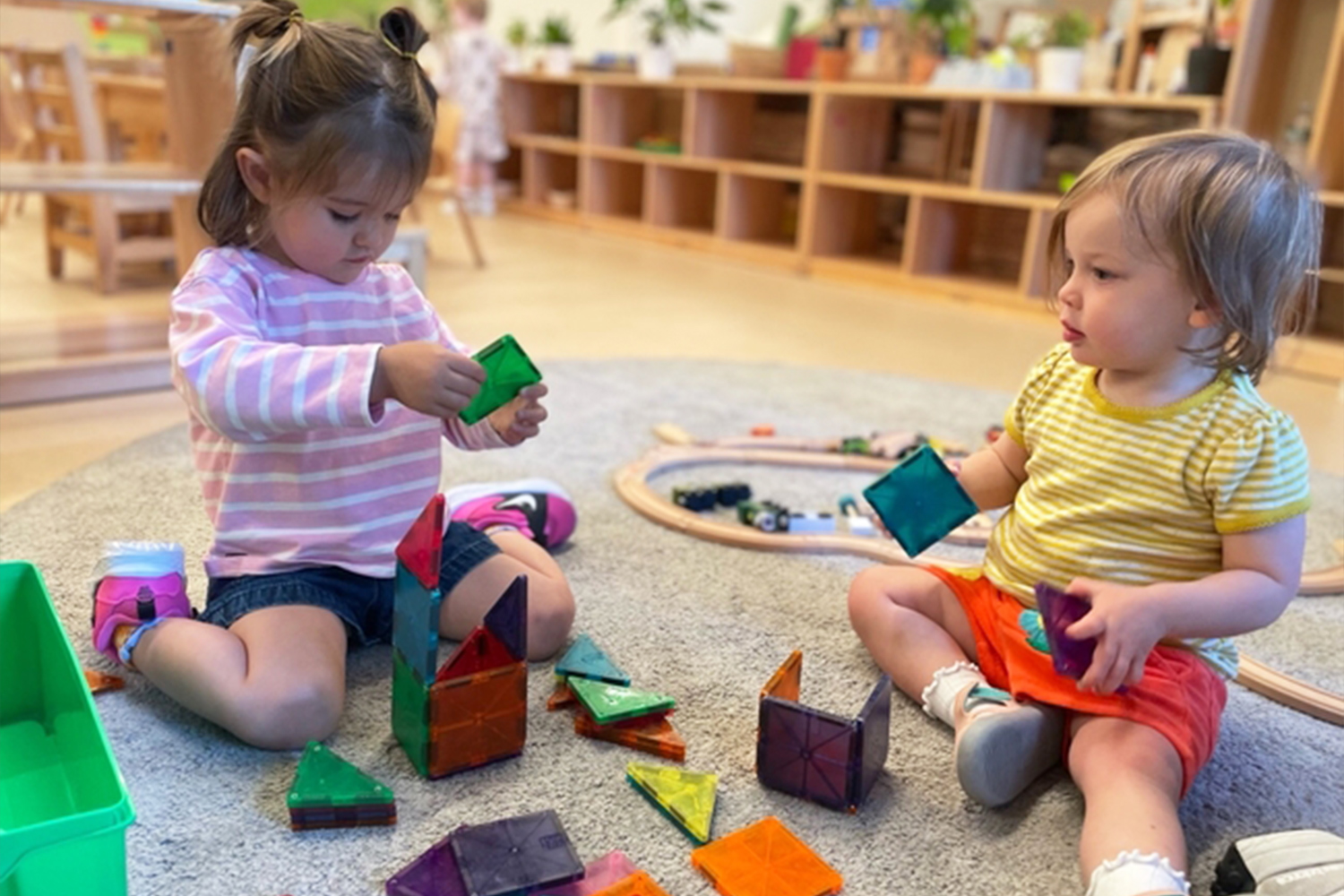 Two students in Extended Day program playing with magnetic tiles