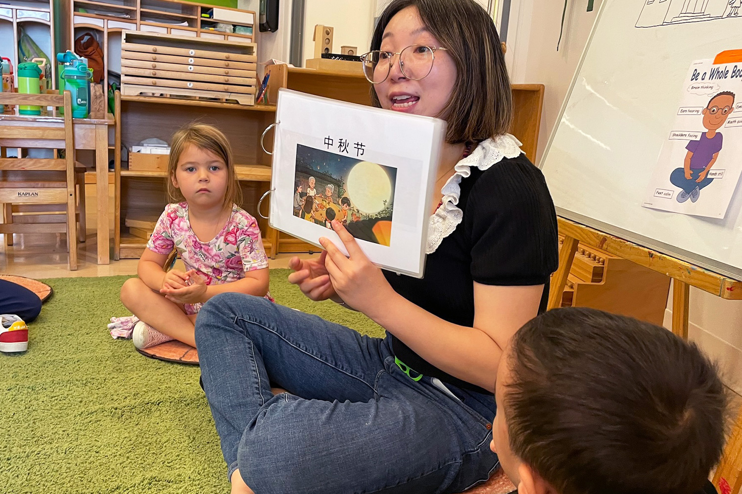 Battery Park Montessori Mandarin teacher shares a booklet depicting Mid-Autumn Festival with her students.