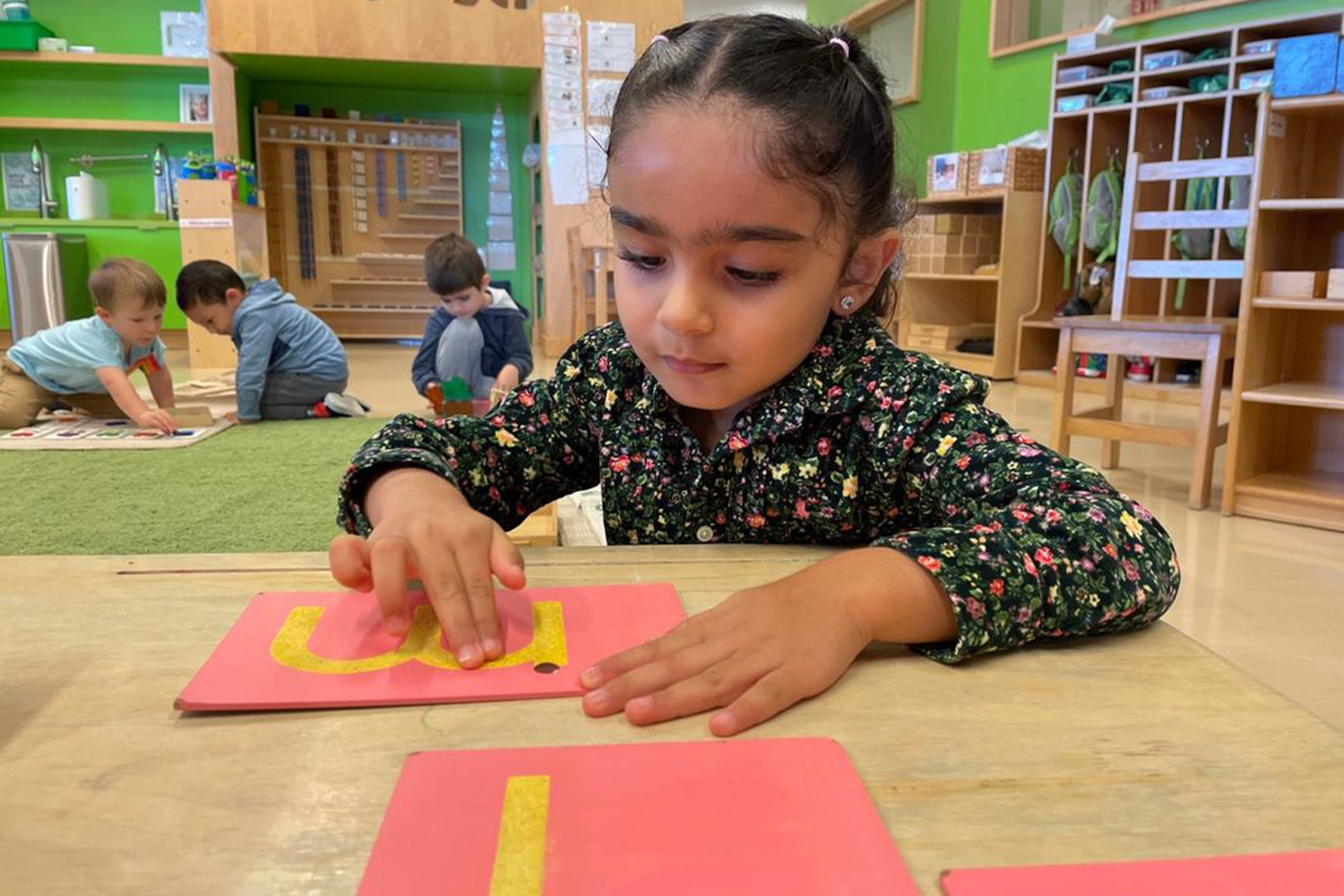 Student discovering Montessori tactile letters.
