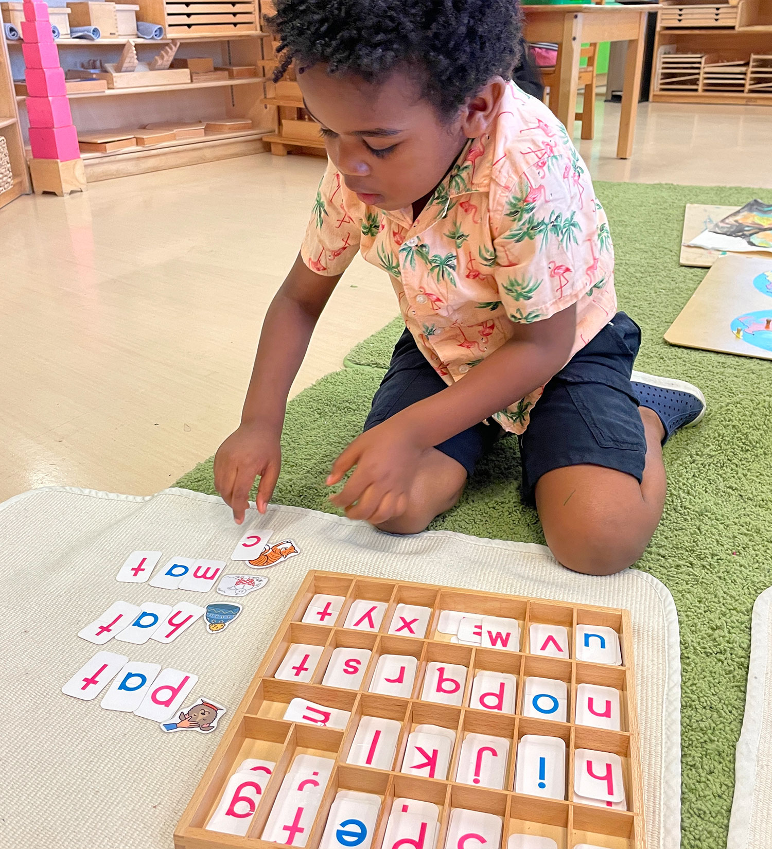 Student putting together CVC words in a Montessori Language work