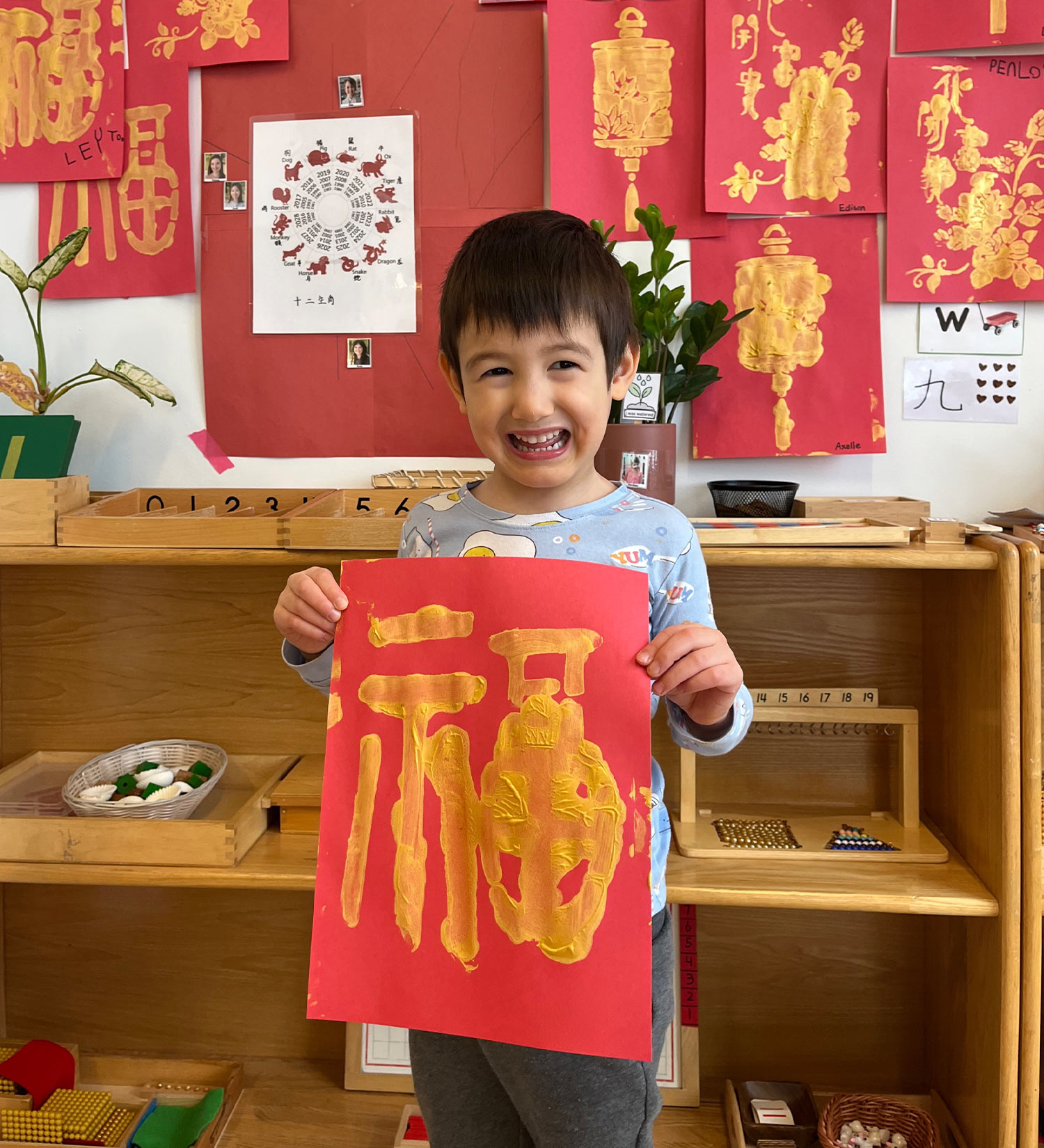 A student proudly holds up his Fu Characters (福字) as part of Battery Park Montessori's Lunar New Year festivities.