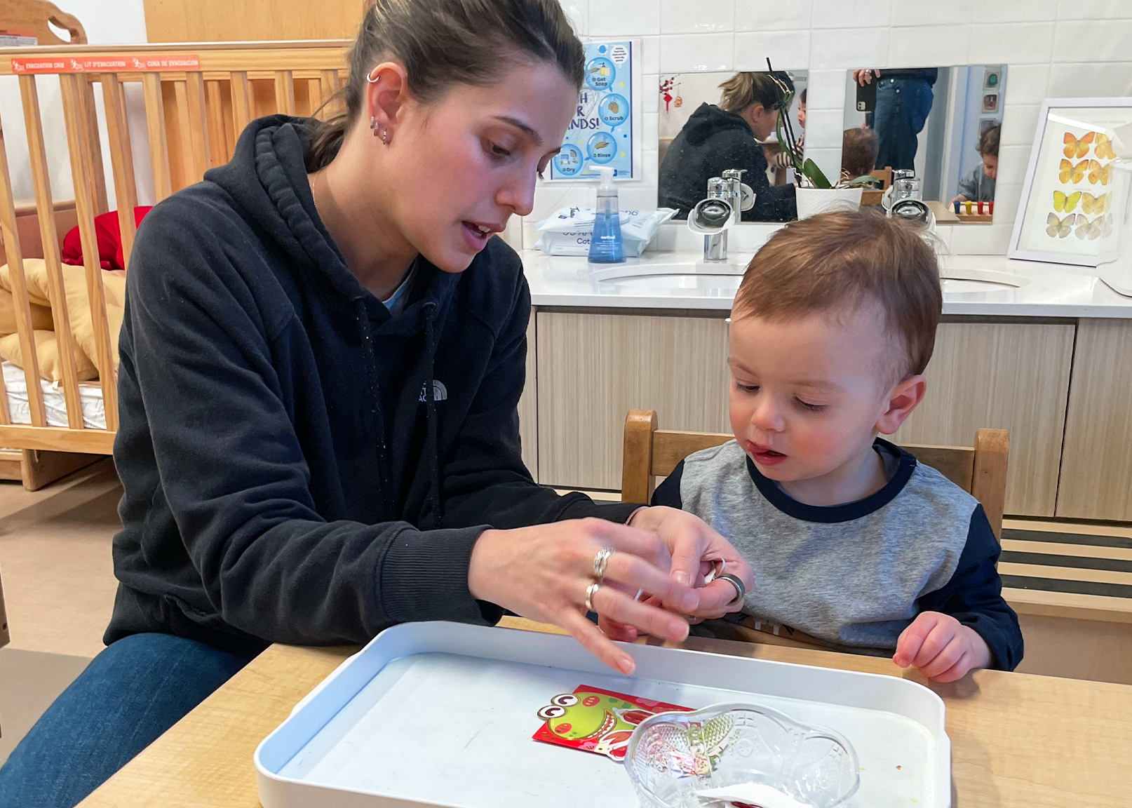 Battery Park Montessori teacher demonstrates an activity to a student