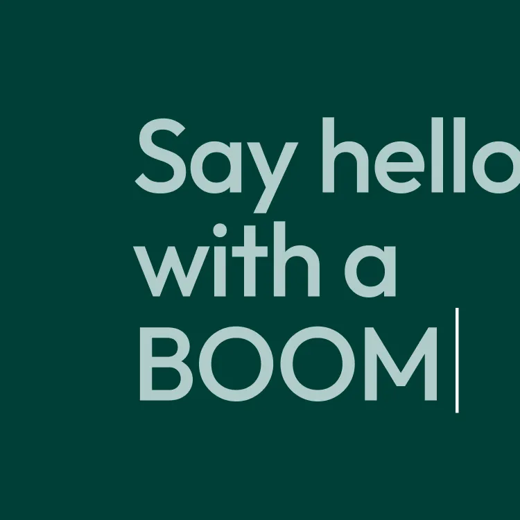 Text on dark green background saying 'Say hello with a BOOM' with a vertical cursor line at the end.