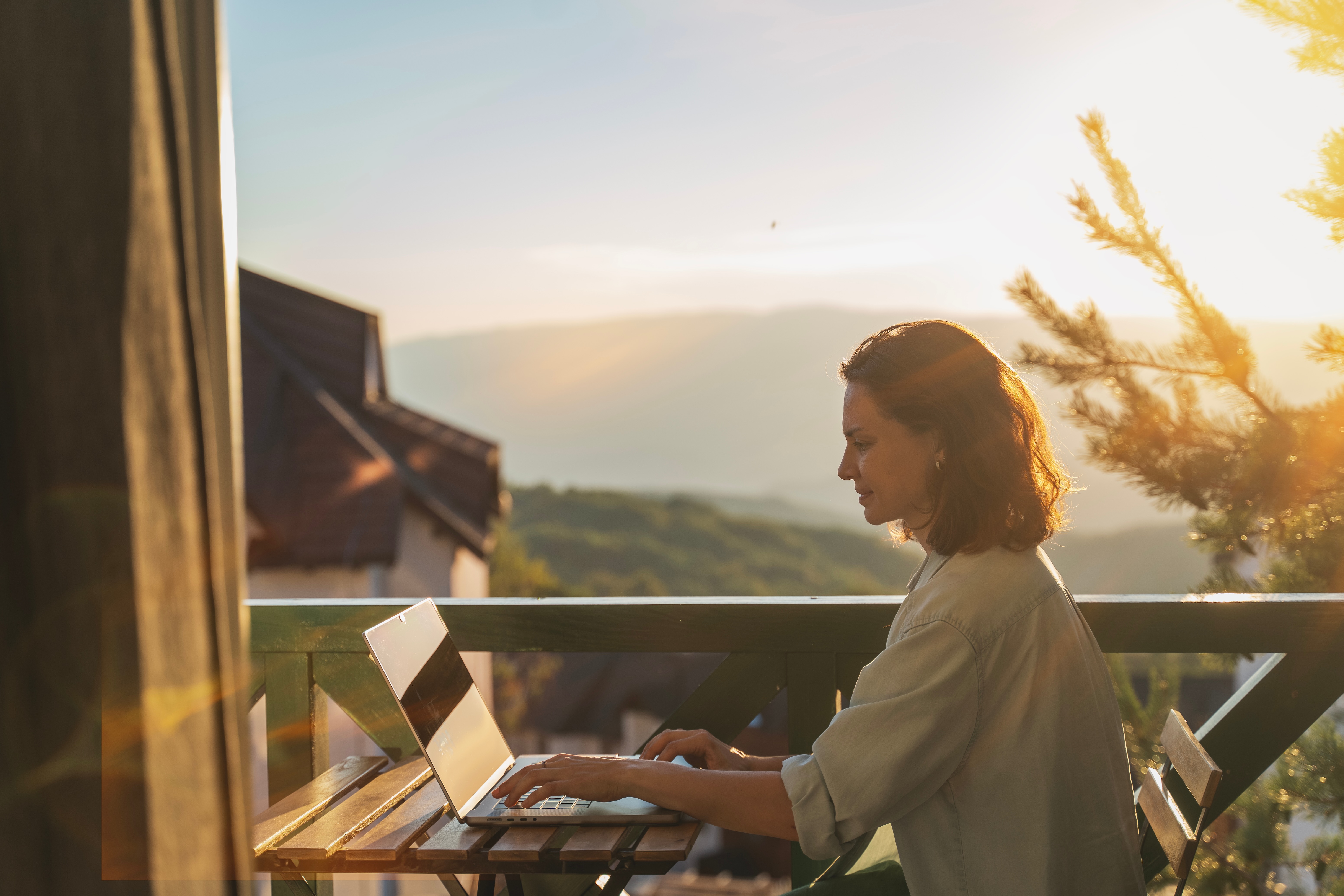 Person working on patio with mountain view stock image