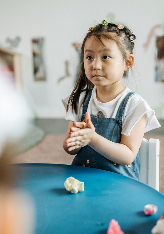Toddler participating in a hands-on learning activity at Spring Bilingual Daycare.