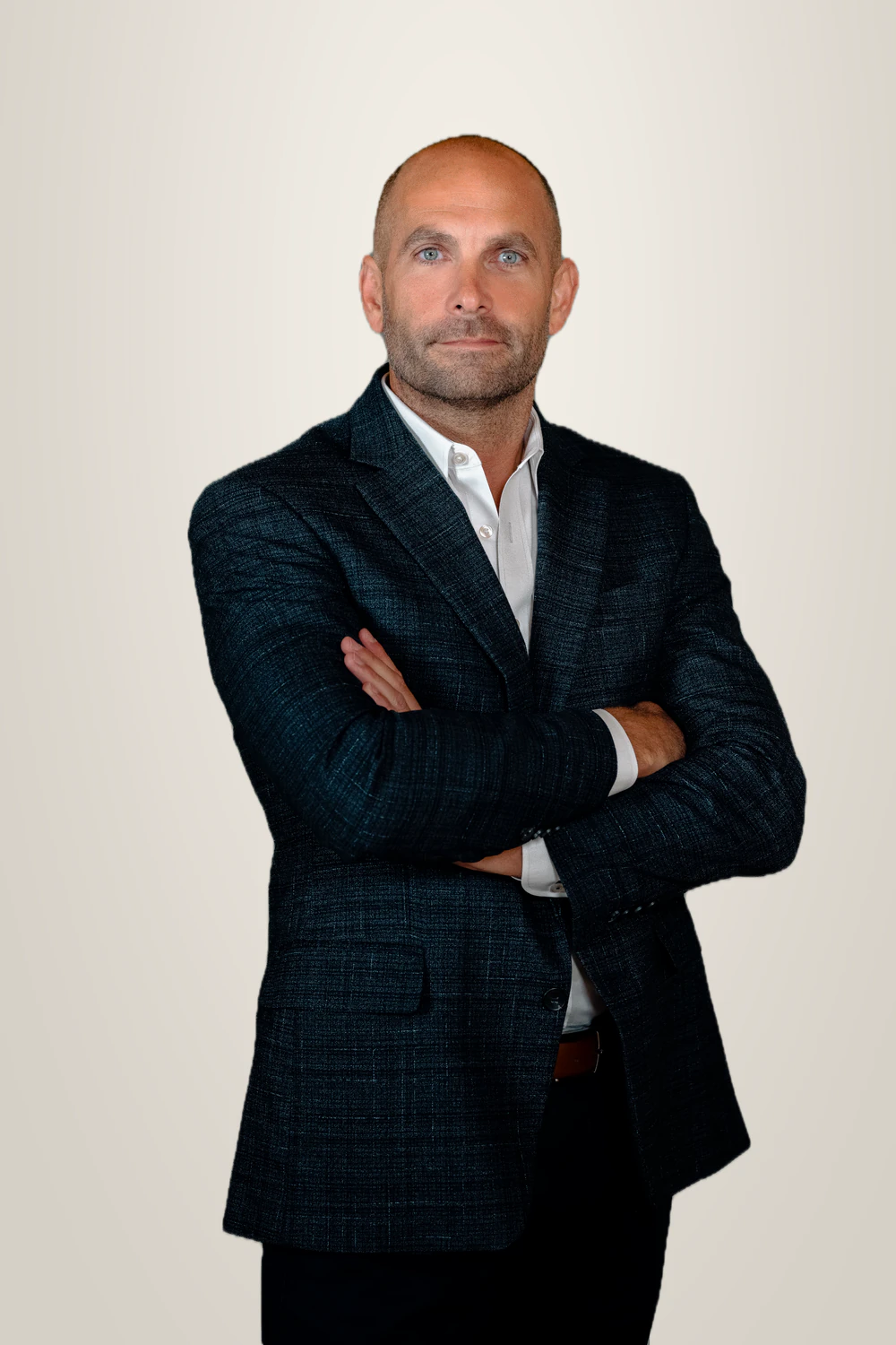 John Mathews, founder of JM Consulting, in a dark jacket with arms folded